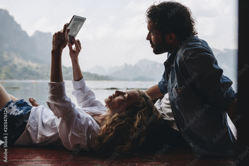 Woman relaxing in her boyfriends lap