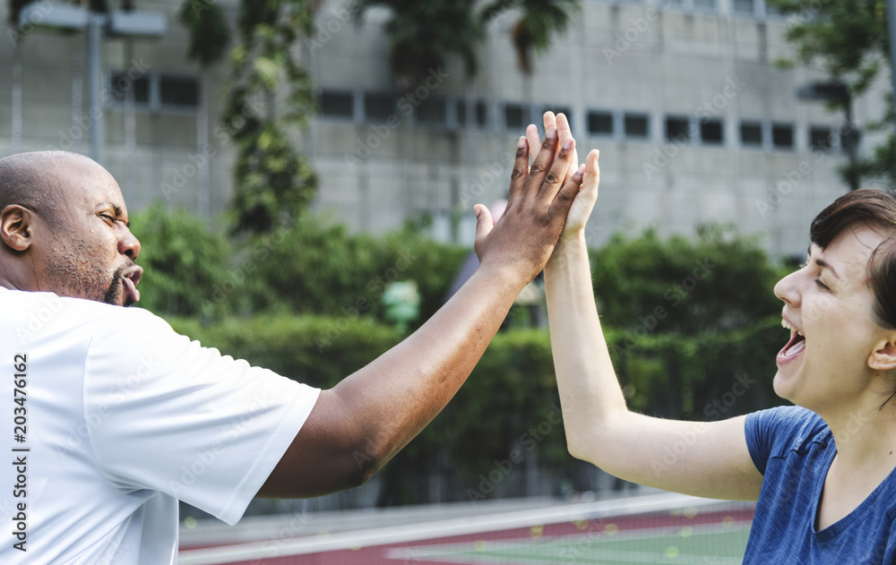 Couple playing tennis as a team