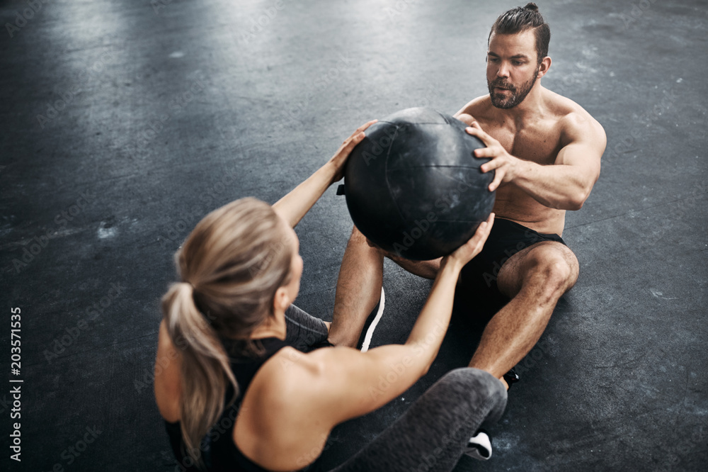 Fit people exercising with a medicine ball at the gym