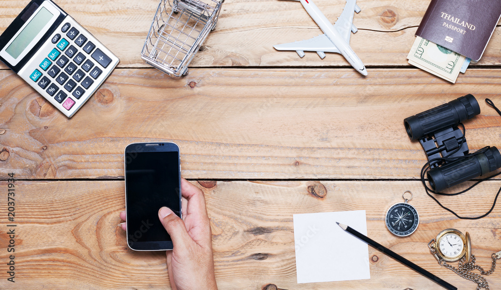 Hand man use tablet smartphone with Office desk wood table of Business workplace and business object