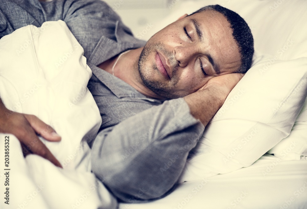 A man sleeping on a bed