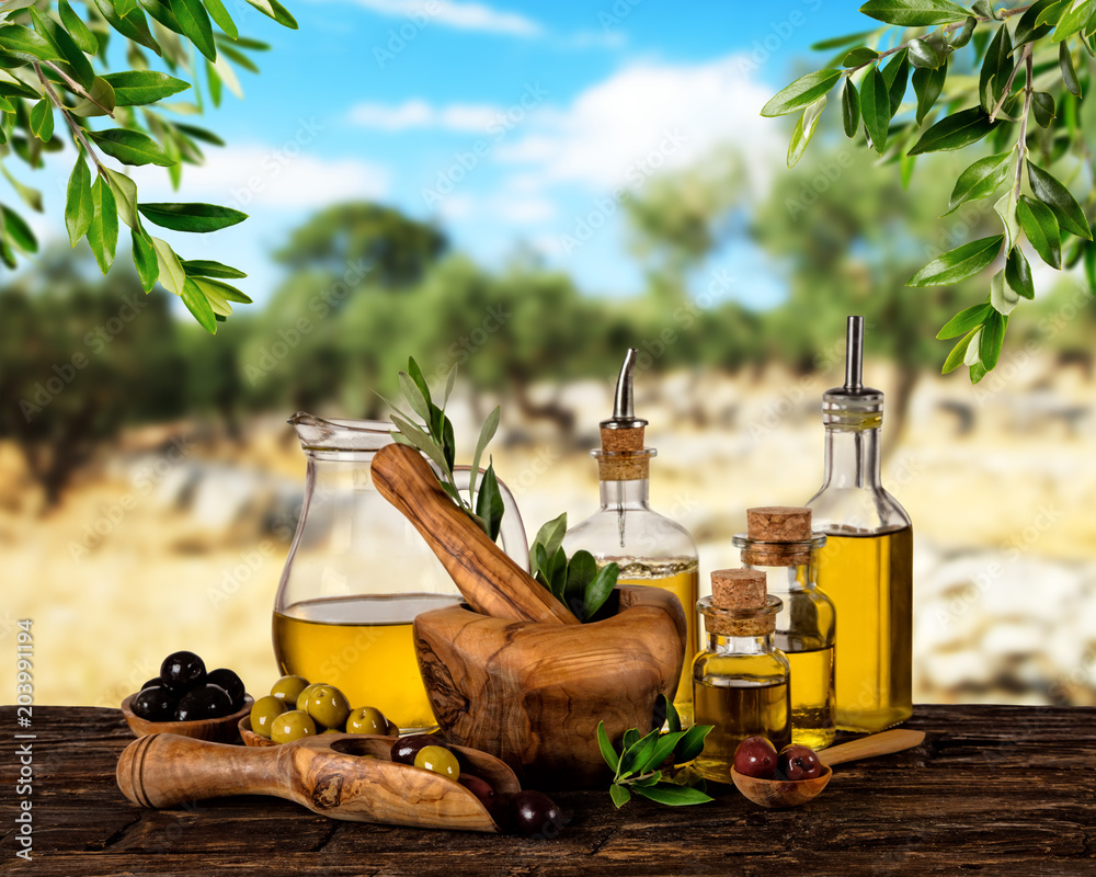 Fresh harvested olives with oil, placed on wooden table