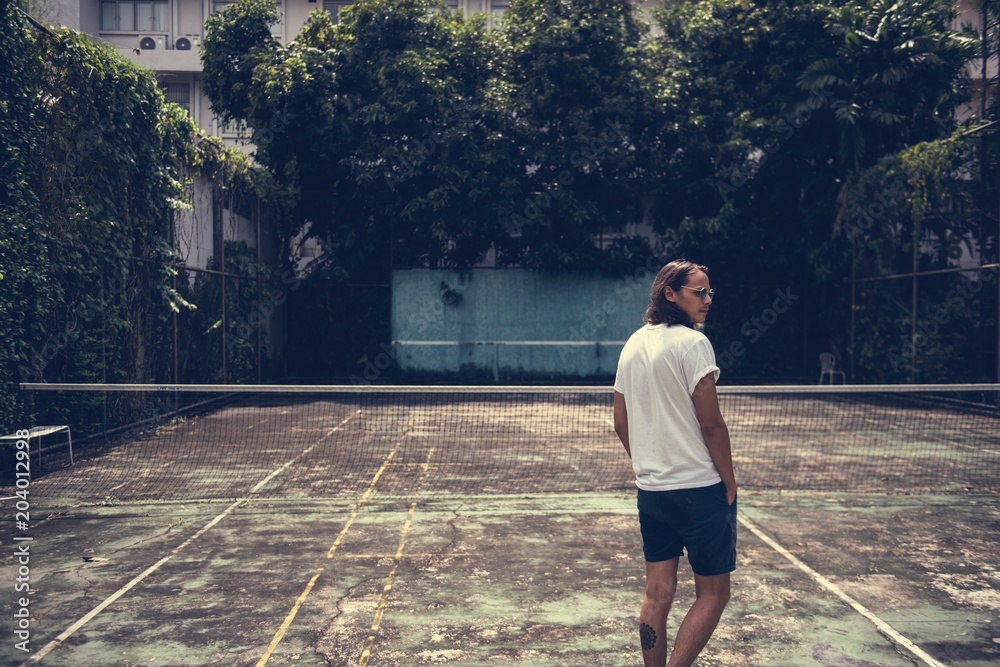 Man standing in a tennis court