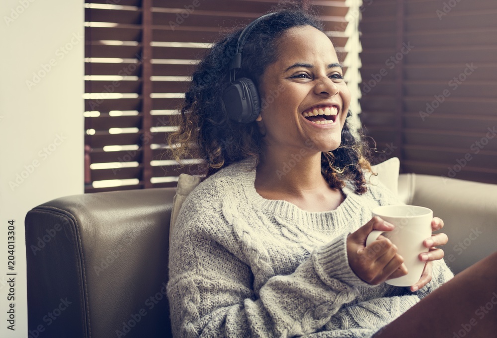 Woman enjoying music on her sofa