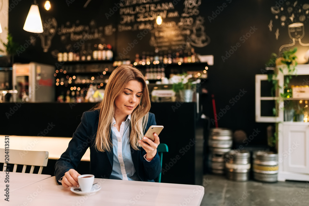 Modern business woman enjoying a cup of coffee at the cafe.