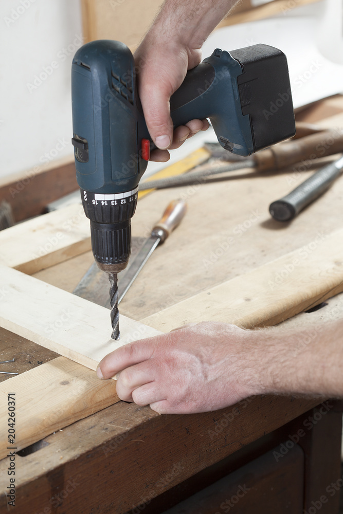 carpenter using electric drill