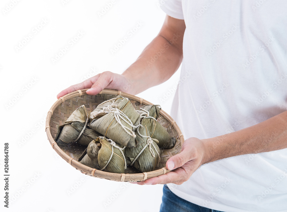 A man is giving zongzi or rice dumpling to others as a present or souvenir on Dragon Boat Festival, 