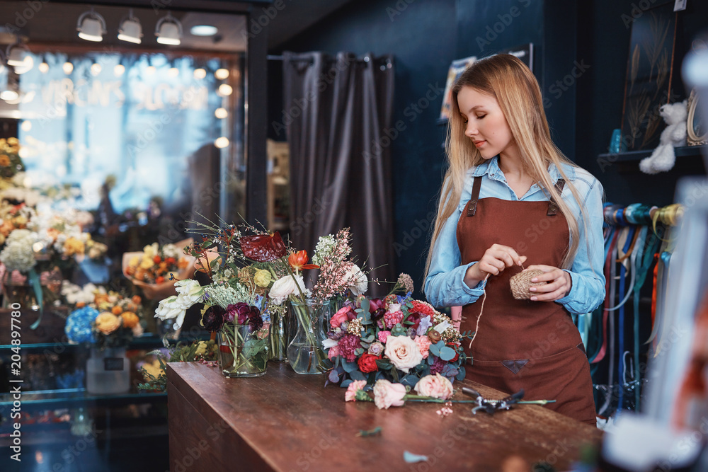 Young florist in an apron