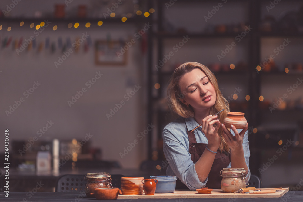 Attractive girl in a pottery studio