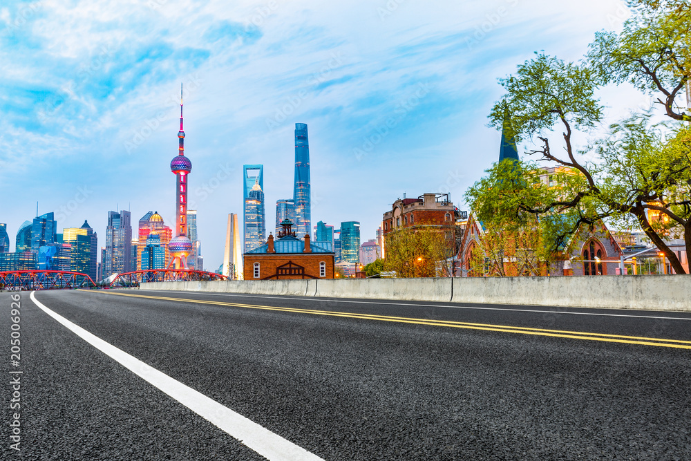 clean asphalt road with city skyline background,shanghai,china