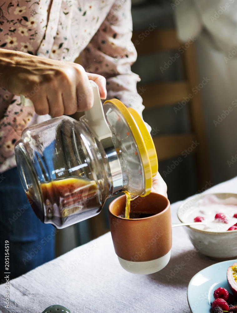 Woman serving hot coffee for breakfast