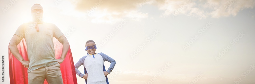 Composite image of father and son pretending to be superhero