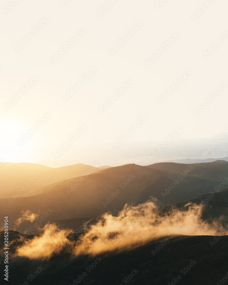 Picturesque summer landscape with colorful sunrise on Carpathian mountains. Mountain ranges in morni