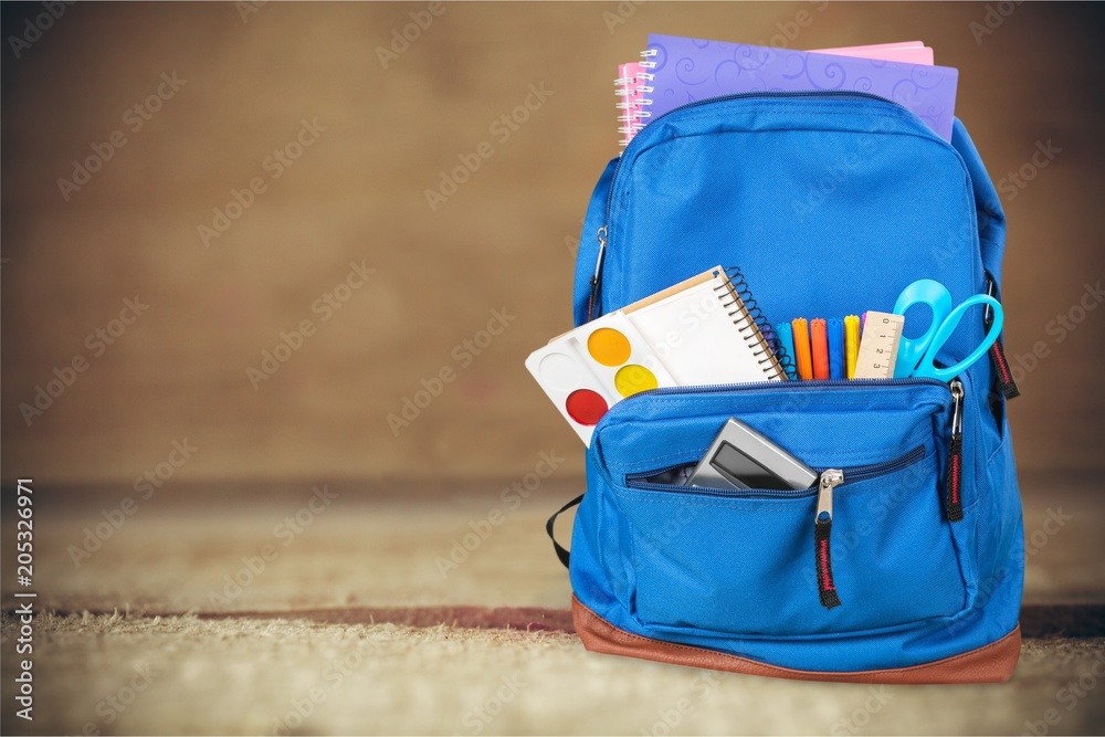 School bag on wooden background.