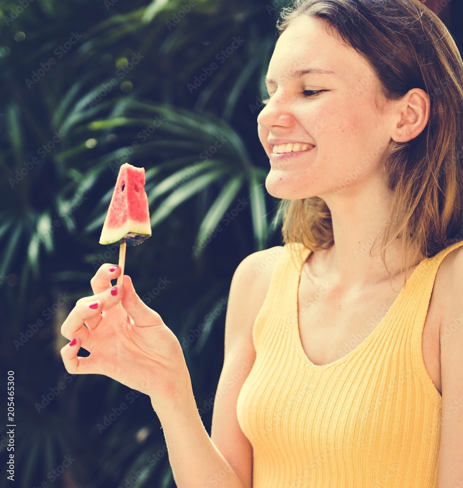 Caucasian woman eating watermelon in summertime