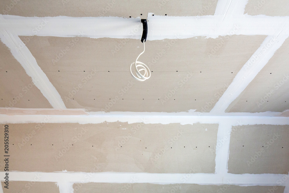 Empty bedroom interior with gypsum board ceiling at renovation