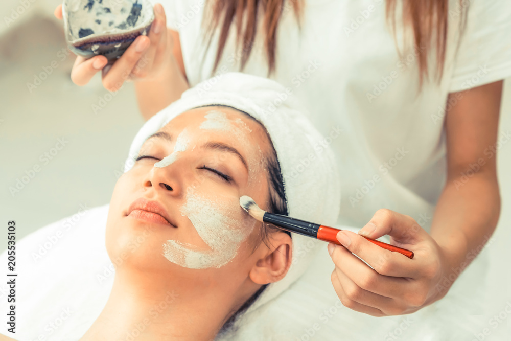 Beautiful woman having a facial treatment at spa.