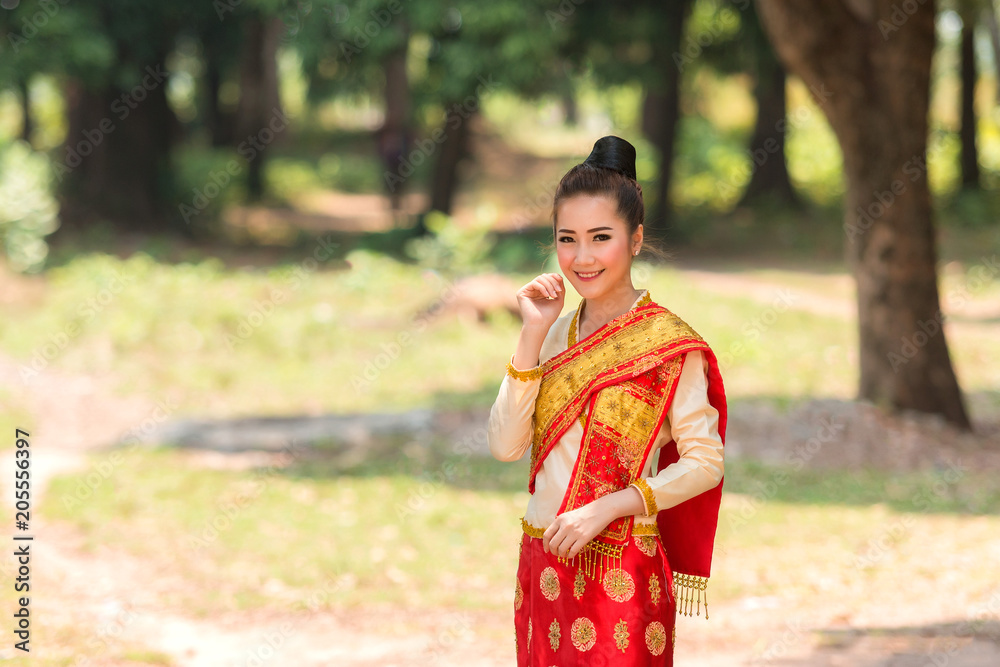 Beautiful girl in Laos costume,Asian woman wearing traditional Laos culture at temple.Vintage style.