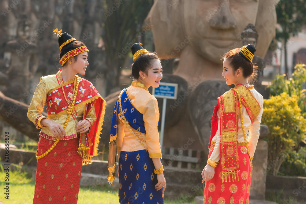 Beautiful girl in Laos costume,Asian woman wearing traditional Laos culture at temple.Vintage style.