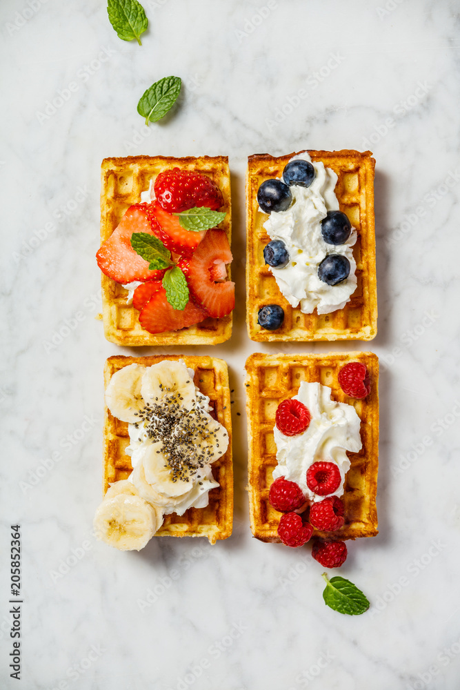 Traditional belgian waffles with whipped cream and fresh fruits 