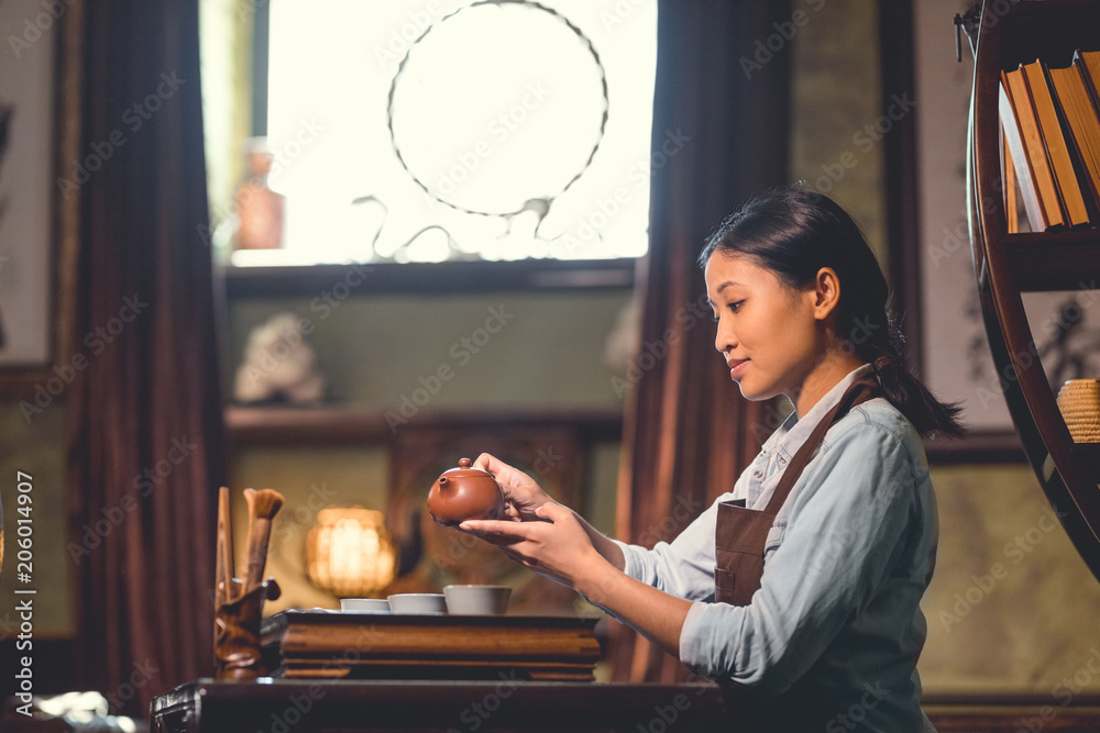 Young woman pouring tea