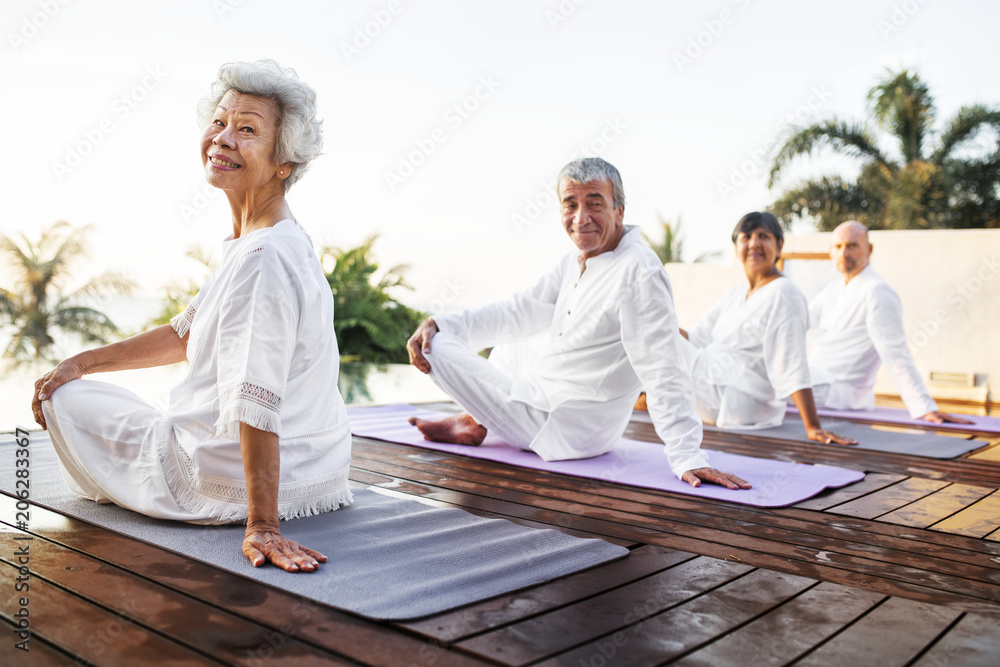 Group of seniors practicing yoga