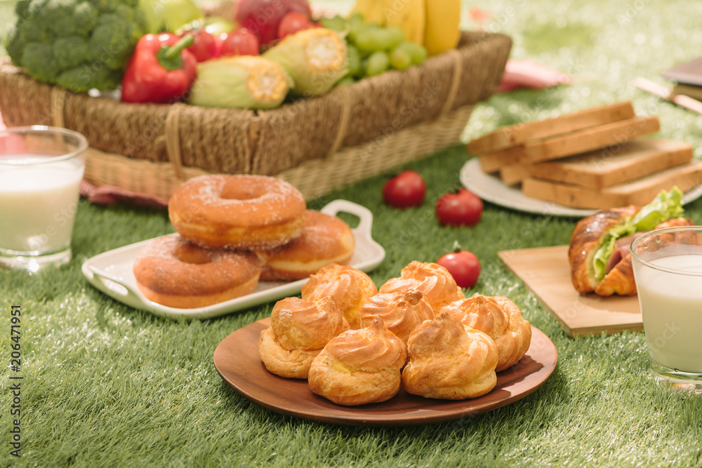 Healthy picnic for a summer vacation with freshly baked croissants, fresh fruit and fruit salad, san