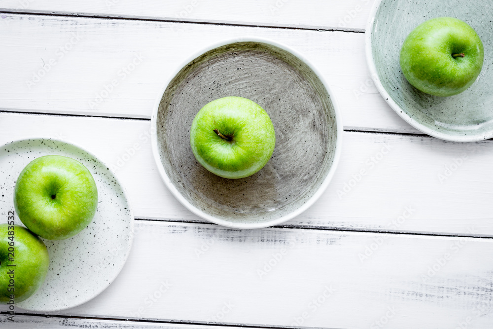 Healthy green food with apples on plates white background top vi