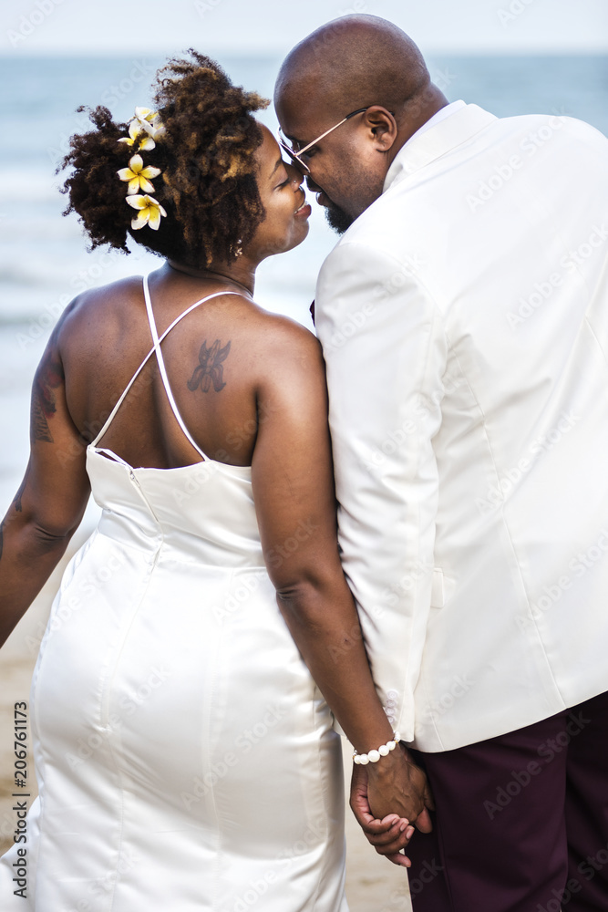 African American couple getting married at the beach