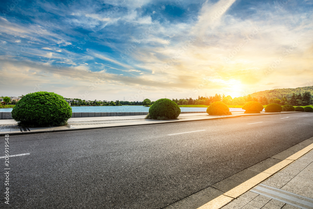 Asphalt road and apartment building with cloud landscape in the city suburbs