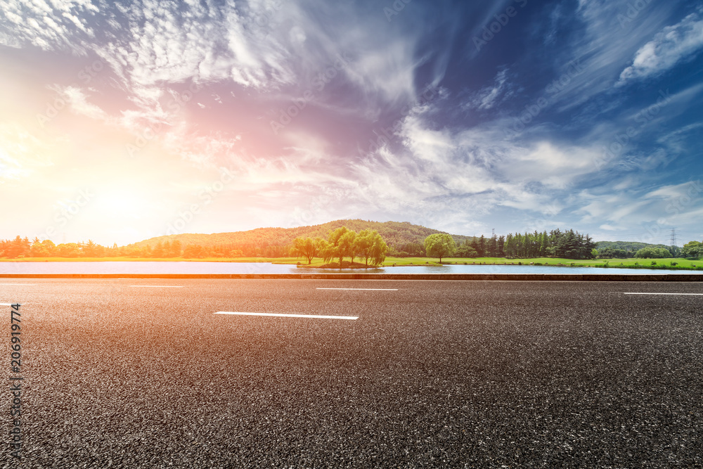 Asphalt road and mountain with sky clouds landscape at sunset