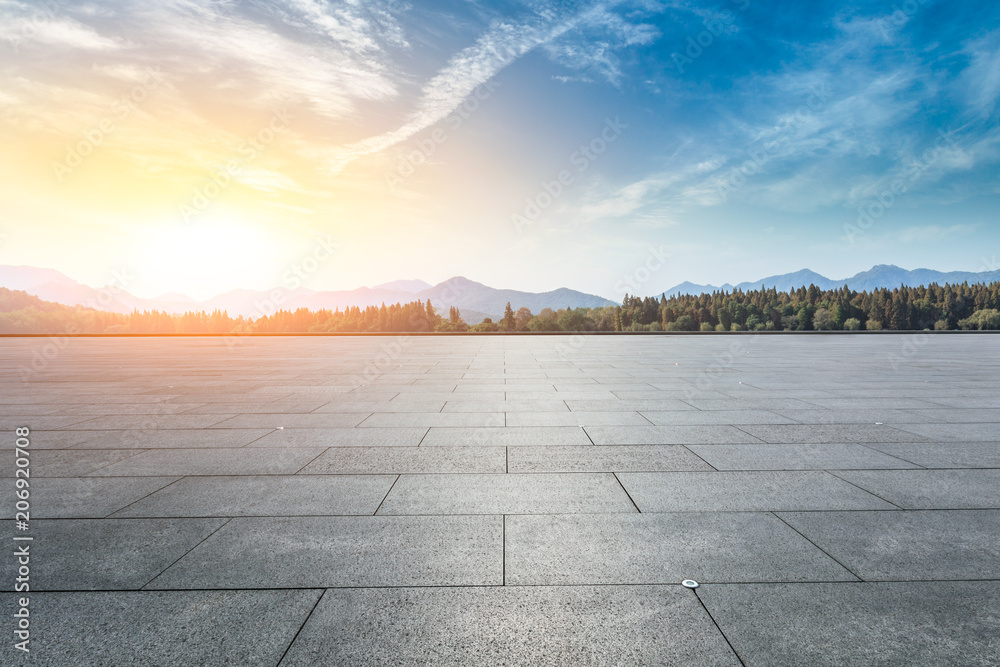 Empty square floor and hills landscape at sunset