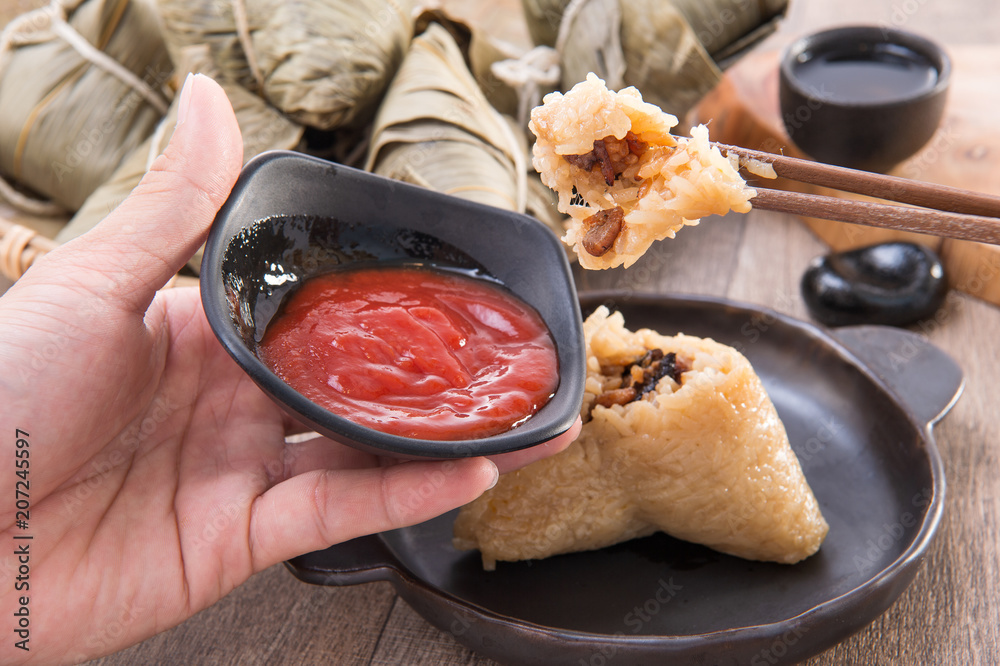 A man is going to eat zongzi or rice dumpling on Dragon Boat Festival, Asian traditional food