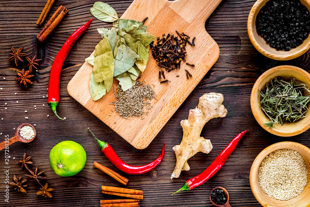 Cooking with spices, salt and pepper on kitchen table background