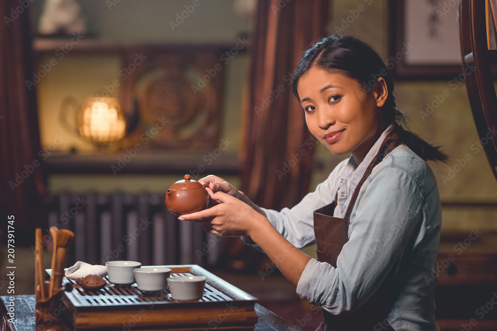 Young tea master in room