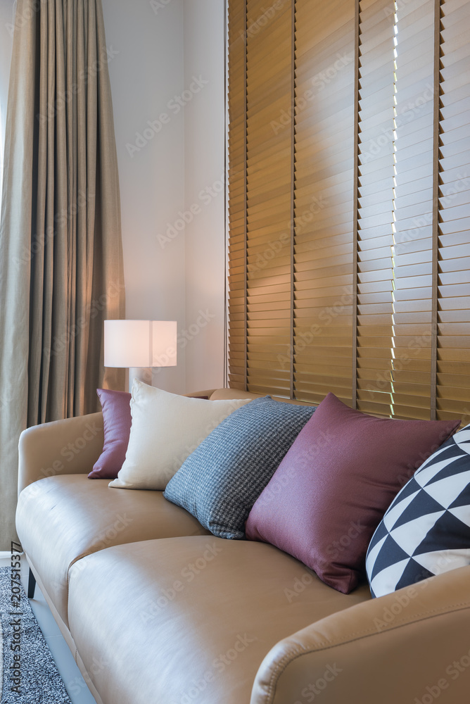 brown sofa with colorful pillows