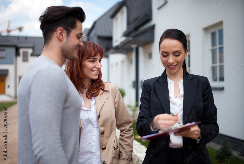 Real estate agent offer ownership contract for new house to young couple