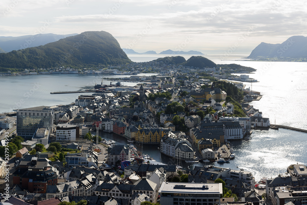 Colorful sunset in Alesund port town on western coast of Norway. Place where the ocean meet the moun