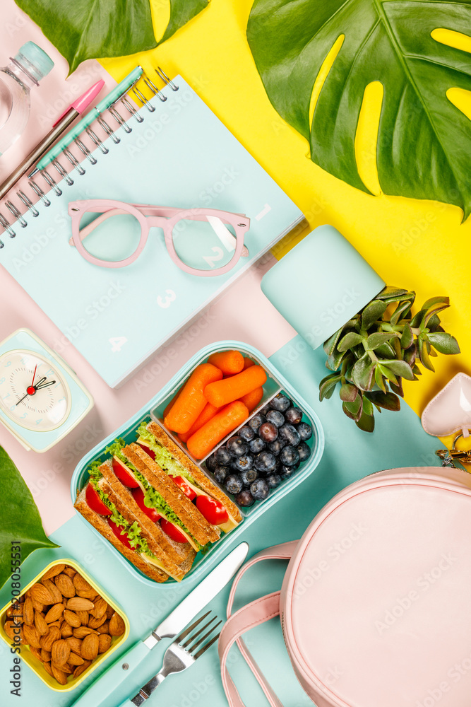 Creative flat lay with healthy lunch and office or school supplies