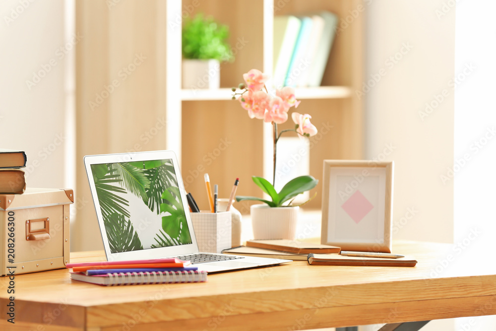 Comfortable home workplace with laptop on table