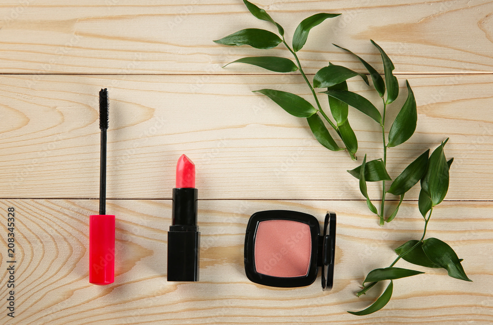 Flat lay composition with decorative cosmetics on wooden background