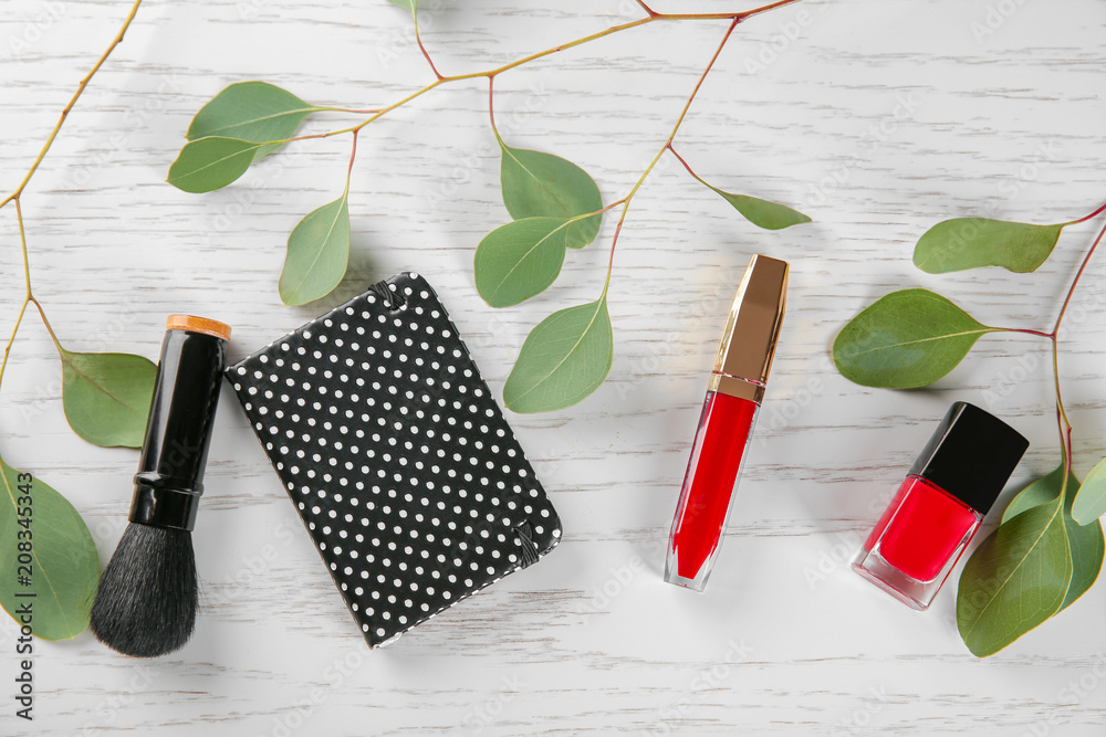 Flat lay composition with decorative cosmetics on wooden background