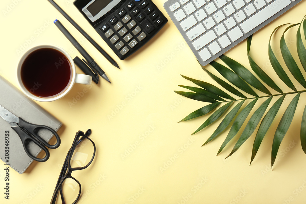 Computer keyboard, cup of coffee and calculator on color background, flat lay. Workplace table compo