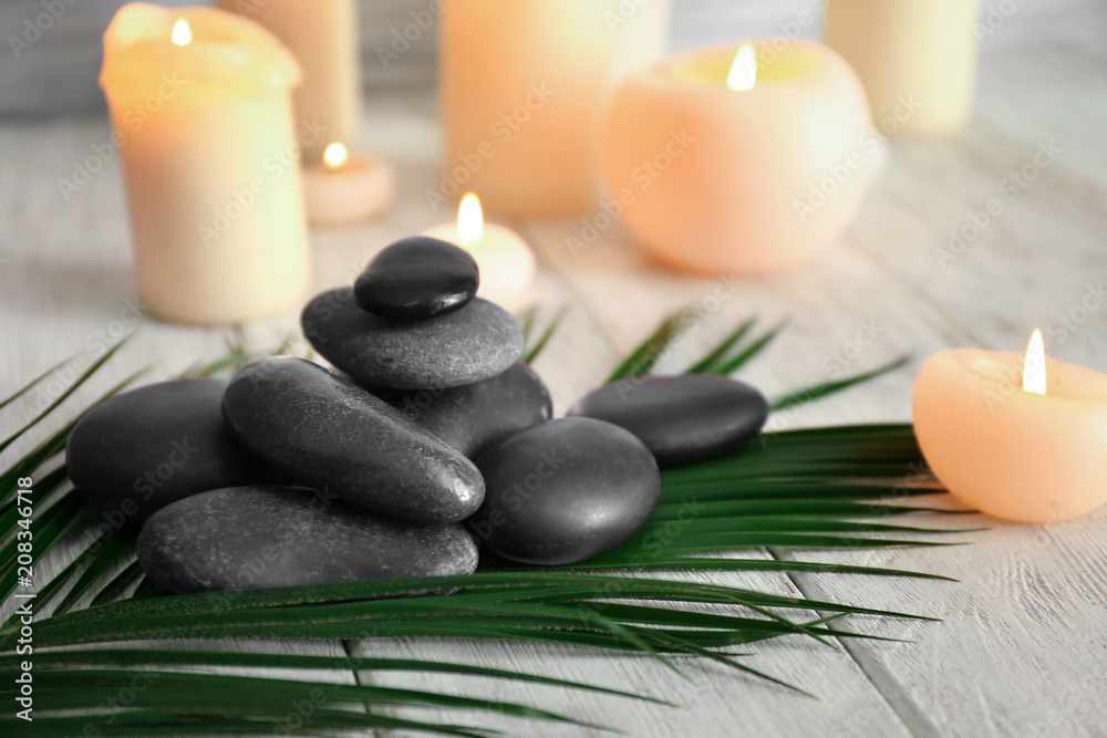 Beautiful composition with spa stones on wooden table