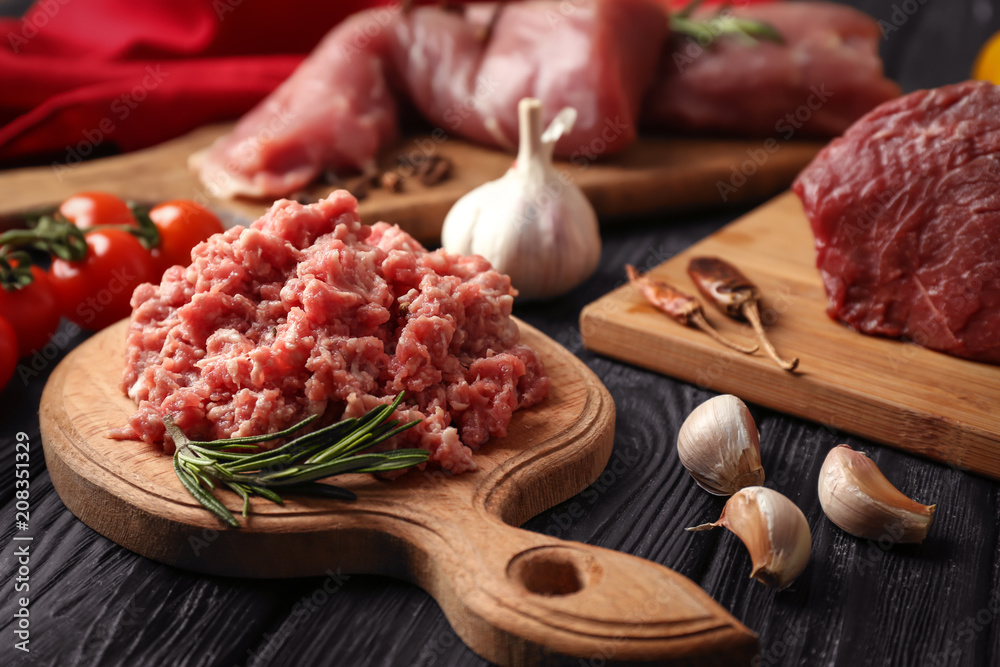 Fresh minced meat with garlic on dark table