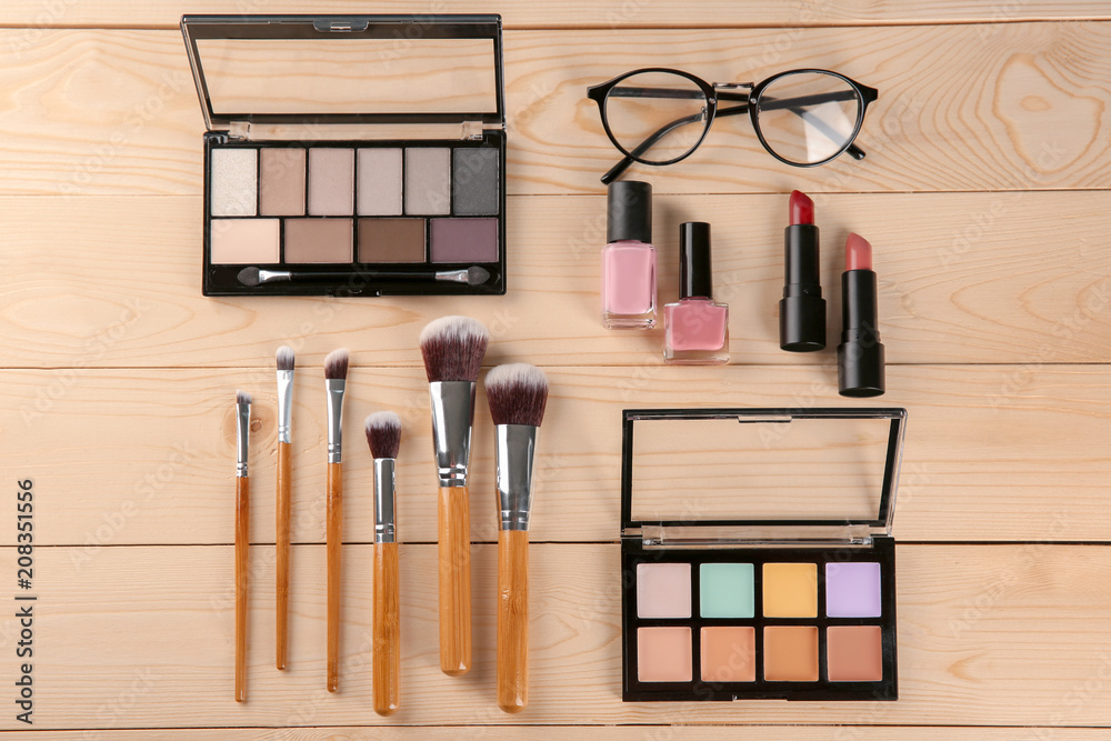 Flat lay composition with professional cosmetics on wooden background