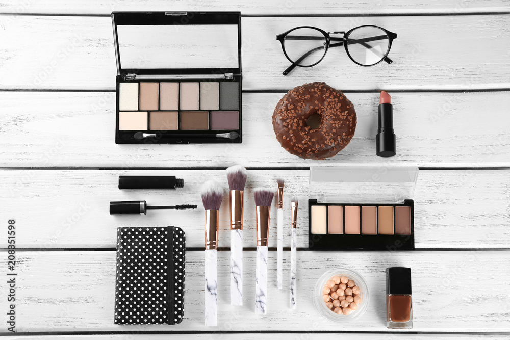 Flat lay composition with professional cosmetics on wooden background