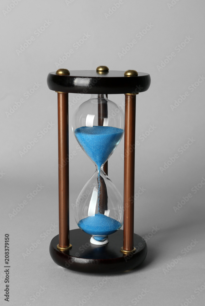 Hourglass on grey background. Time management concept