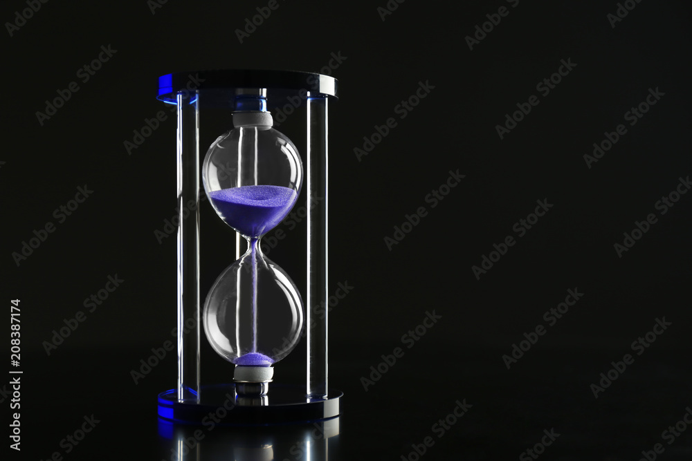 Crystal hourglass on dark background. Time management concept