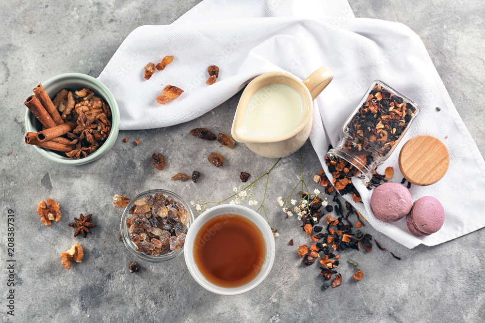 Flat lay composition with tea, milk and treats on table